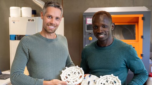 Two men with two additively manufactured components