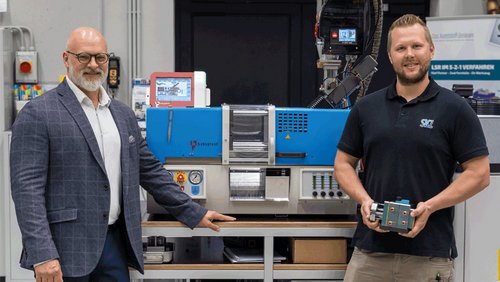 Marc Tesche (links), Geschäftsführer CHRISTMANN Kunststofftechnik GmbH, und Christoph Mussauer (rechts), Leitung Spritzgießtechnikum, vor der neuen SKZ-Maschine mit einem ersten Werkzeug
